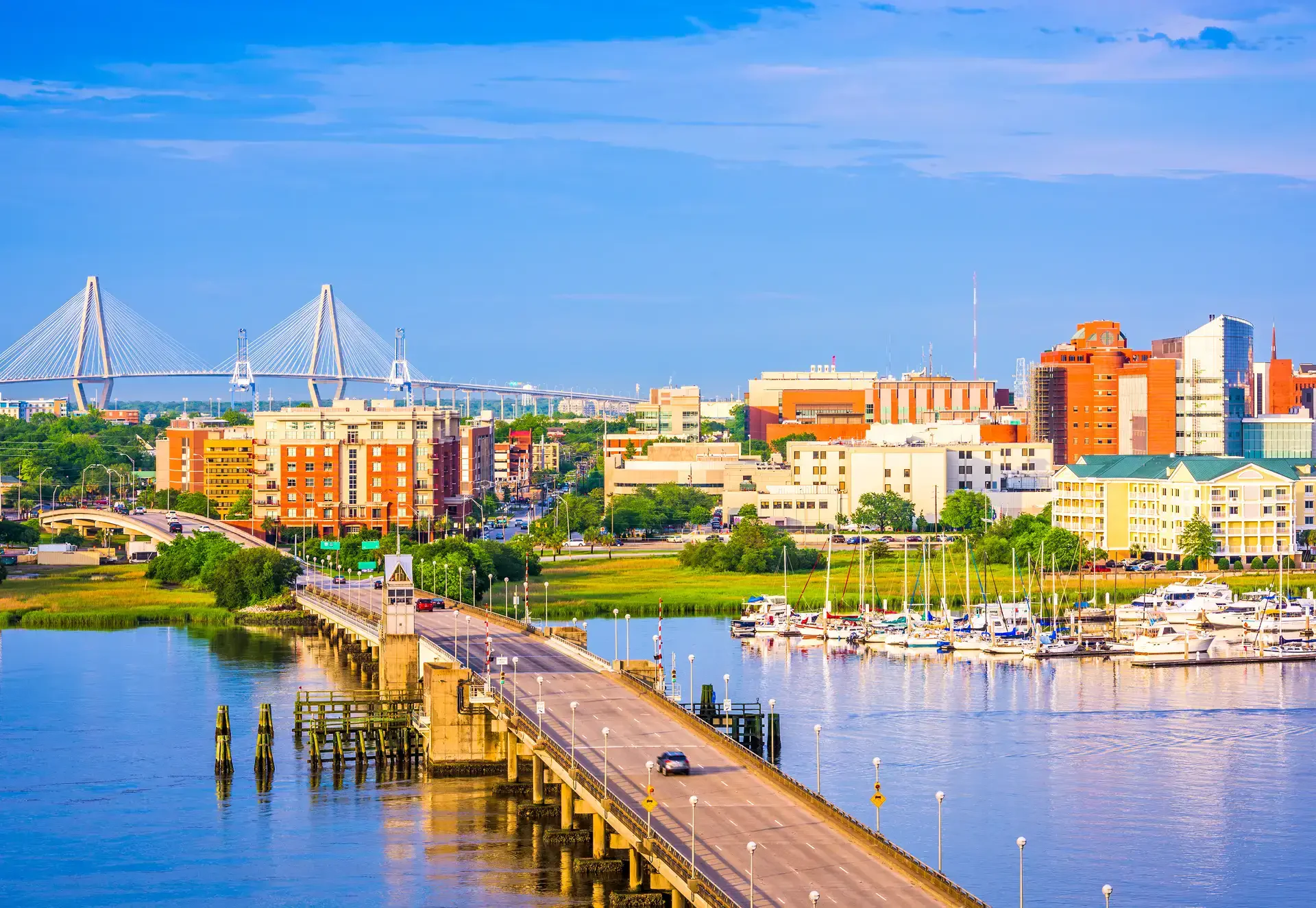 A bridge spans across a calm body of water, reflecting the surrounding landscape.